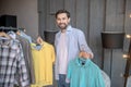 Handsome young man choosing a tshirt for today. Royalty Free Stock Photo