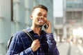 Handsome young man in city talking on smart phone Royalty Free Stock Photo