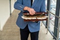 handsome young man in a classic suit with a tie holds in his hands a bag of euros. Royalty Free Stock Photo