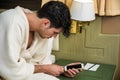 Handsome Young Man Connecting a Phone to a Charger