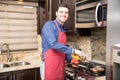 Handsome young man cooking breakfast at home Royalty Free Stock Photo