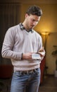 Handsome young man counting money, indoors shot Royalty Free Stock Photo