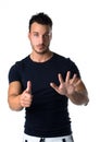 Handsome young man counting to six with fingers and hands Royalty Free Stock Photo