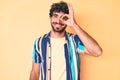 Handsome young man with curly hair and bear wearing summer shirt and sunglasses smiling happy doing ok sign with hand on eye Royalty Free Stock Photo