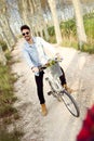 Handsome young man cycling in the park. Royalty Free Stock Photo