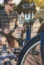 Handsome Young Man Cyclist Pumps Bicycle Wheel Maintenance Transport Concept Royalty Free Stock Photo