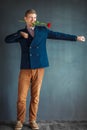 Handsome young man dancing with a red rose in his mouth Royalty Free Stock Photo