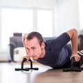 Handsome young man doing push-up at home Royalty Free Stock Photo