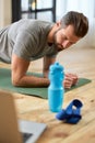 Handsome young man doing strength exercise at home Royalty Free Stock Photo