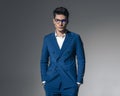 handsome young man in double breasted blue suit holding pockets Royalty Free Stock Photo
