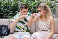 Handsome young man drink coffee with her fiancee in cafe on terrace Royalty Free Stock Photo