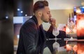 Handsome young man drinking cocktail at bar counter Royalty Free Stock Photo