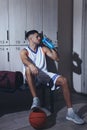 Handsome man drinking water in locker room Royalty Free Stock Photo