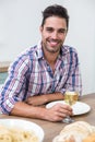 Handsome young man drinking wine at table Royalty Free Stock Photo