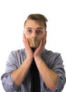 Handsome young man with duct tape on mouth cannot speak Royalty Free Stock Photo