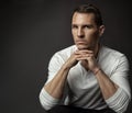 Handsome Young Man. Elegant Fashion Men Face Portrait looking at camera in White Shirt over dark Gray Background. Serious Royalty Free Stock Photo