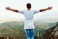 Handsome young man enjoying nature at mountain peak. Royalty Free Stock Photo