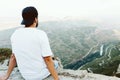 Handsome young man enjoying nature at mountain peak. Royalty Free Stock Photo