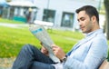 Handsome young man enjoying and reading newspapers