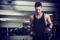 Handsome young man exercising biceps in gym Royalty Free Stock Photo