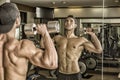 Handsome young man exercising shoulders in gym Royalty Free Stock Photo