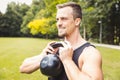 Handsome young man exercising using kettle bell Royalty Free Stock Photo