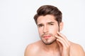 Handsome young man expertising his face before shaving Royalty Free Stock Photo