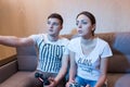 Handsome young man explaining rules of video game to his girlfriend