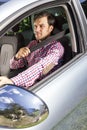 Handsome young man fastening seat belt