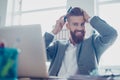 Handsome young man is fixing his hair at the work place. He is s Royalty Free Stock Photo