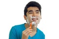 Handsome young man with foam on his face shaves his beard and laughs Royalty Free Stock Photo