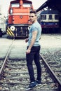 Handsome young man in front of old train, looking away Royalty Free Stock Photo