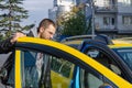 A handsome young man getting in to a taxi