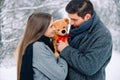 Handsome young man gives to his girlfriend a brown toy bear. Portrait of sweet couple hugging soft present looking cute Royalty Free Stock Photo