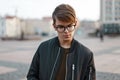 Handsome young man with glasses on the background of the city Royalty Free Stock Photo