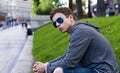 Handsome young man with glasses sitting on the grass Royalty Free Stock Photo