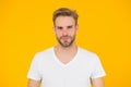 Handsome young man. Good looking guy unshaven face. Hipster with bristle wear white t-shirt. Handsome man posing Royalty Free Stock Photo