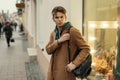 Handsome young man with a haircut in a stylish trendy coat Royalty Free Stock Photo