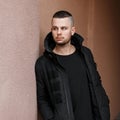 Handsome young man with a hairdo in a stylish black warm jacket Royalty Free Stock Photo