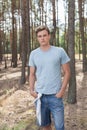 Handsome young man hiking in forest Royalty Free Stock Photo