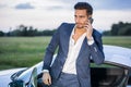 Handsome young man by his car with cell phone Royalty Free Stock Photo