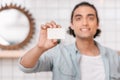 Young man holding blank business card and smiling at camera Royalty Free Stock Photo