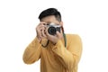 Handsome young man holding DSLR camera on white. Professional male photographer with digital camera shooting in white isolated Royalty Free Stock Photo