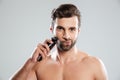 Handsome young man holding electric razor Royalty Free Stock Photo