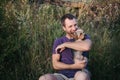 Handsome young man holding and hugs a yorkshire terrier dog Royalty Free Stock Photo