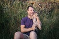 Handsome young man holding and hugs a yorkshire terrier dog Royalty Free Stock Photo