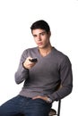 Handsome young man holding remote control, isolated Royalty Free Stock Photo