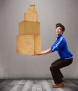 Young man holding a set of brown cardboard boxes