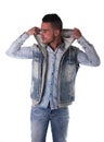 Handsome young man in hoodie, denim vest and jeans