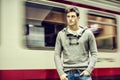 Handsome young man inside train station looking